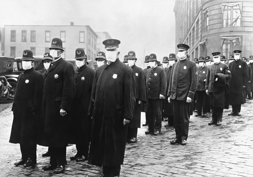 "Policemen in Seattle wearing masks made by the Red Cross, during the influenza epidemic. December 1918." (Wikipedia)